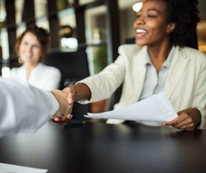 Woman and man share a handshake in agreement