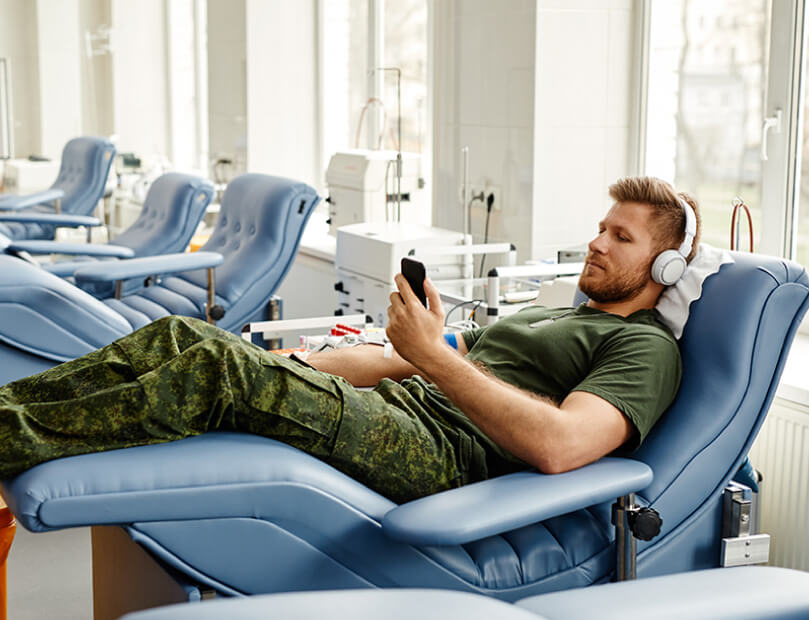 Strong soldier taking time to donate plasma