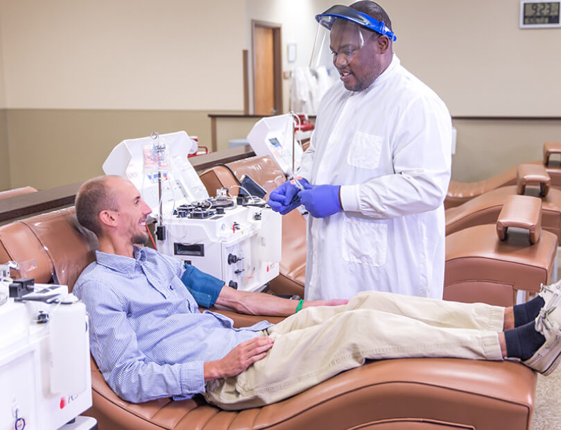 Careful Octapharma tech assists happy donor in center