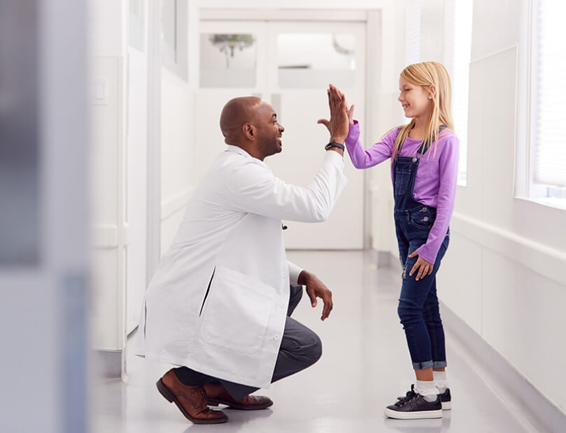 Child and Dr. share happy moment after treatment